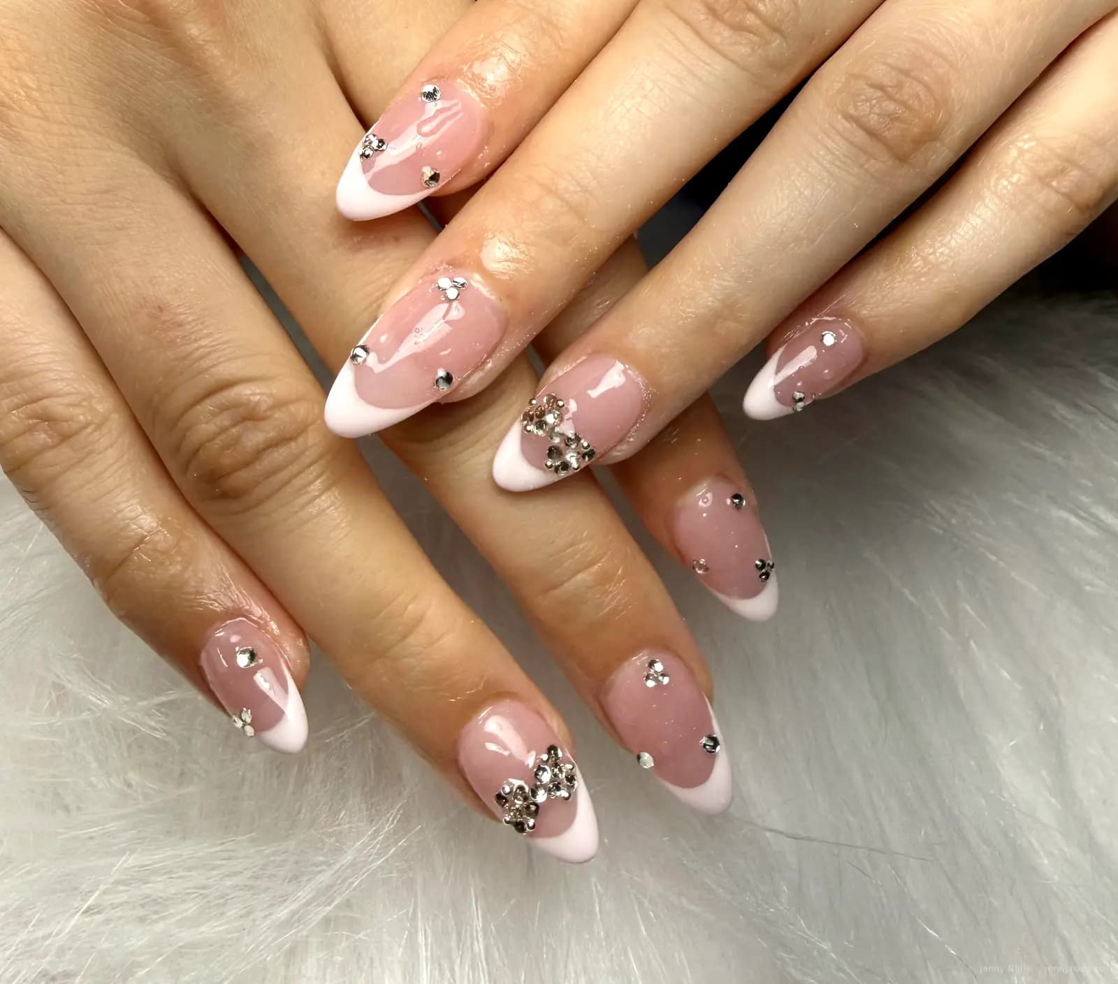 Pink French nails with rhinestone details