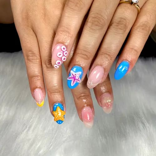 Colorful ocean-themed nails with blue accent art